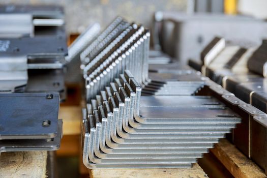 Products bent on a bending machine, close-up. Factory made metal parts.