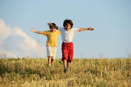 Happy children running on beautiful field
