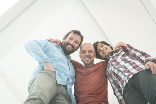 Low angle of father and sons sitting on glass