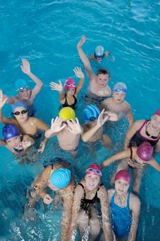 happy children kids group  at swimming pool class  learning to swim