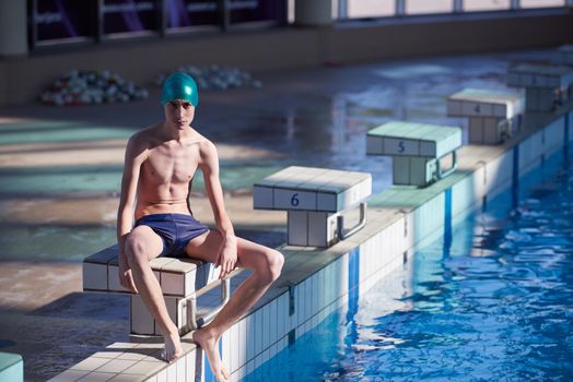 swimmer excercise on indoor swimming pool, sport and health concept