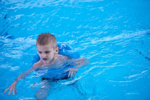 child on swimming pool learning to swim w