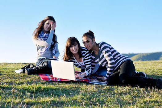 group of teen girl woman outdoor have fun and study homework on laptop computer