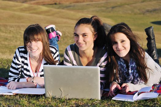 group of teen girl woman outdoor have fun and study homework on laptop computer