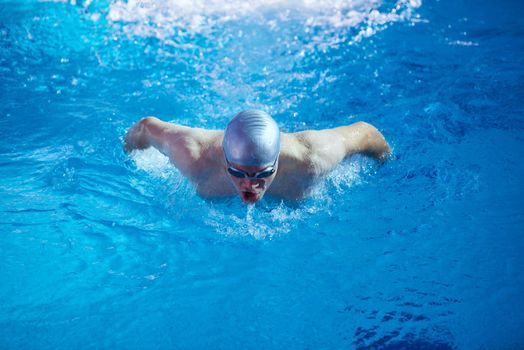 swimmer excercise on indoor swimming pool, sport and health concept