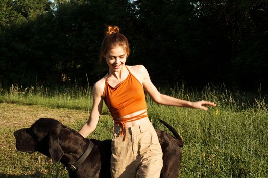 cheerful woman outdoors with dog and fun nature. High quality photo