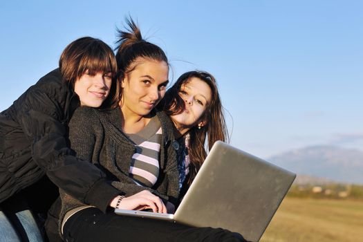 group of teen girl woman outdoor have fun and study homework on laptop computer