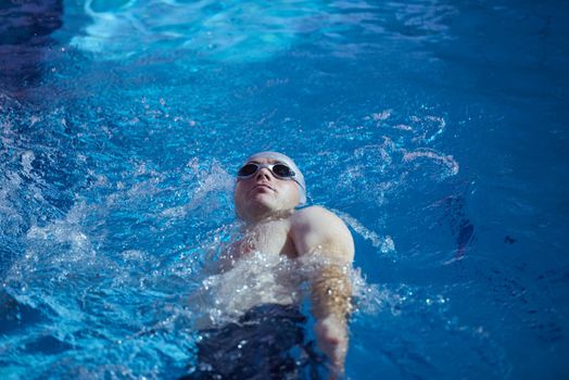 swimmer excercise on indoor swimming pool, sport and health concept