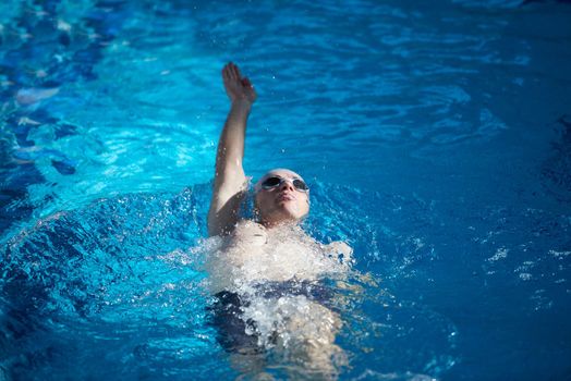 swimmer excercise on indoor swimming pool, sport and health concept