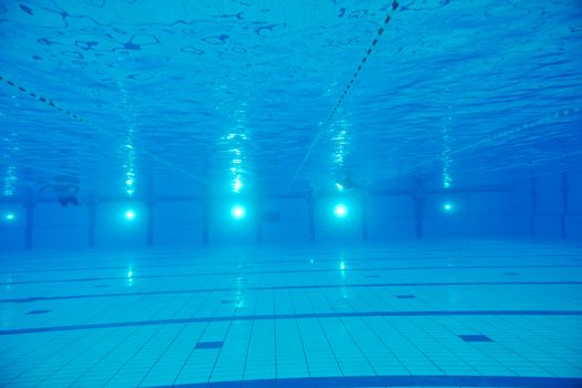 sport swimming pool  underwater with blue color and swimmers