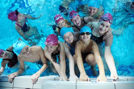 happy children kids group  at swimming pool class  learning to swim