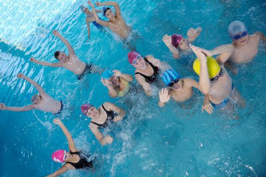 happy children kids group  at swimming pool class  learning to swim