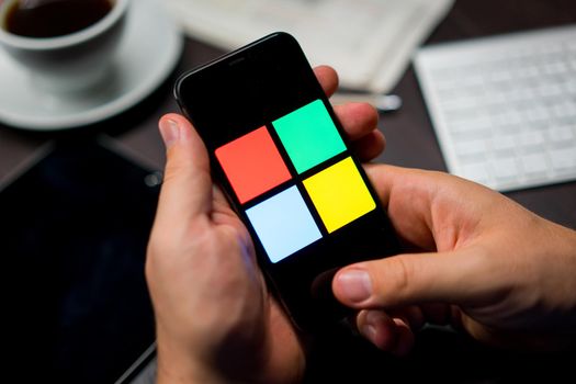 New York, New York / USA - 11 11 2019: Logo of Microsoft Windows on the iPhone X in hands in office