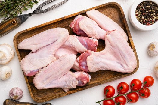 Raw duck wings set, on white stone table background, top view flat lay