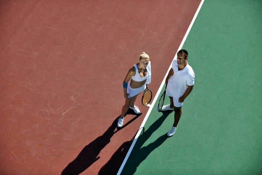 happy young couple play tennis game outdoor man and woman