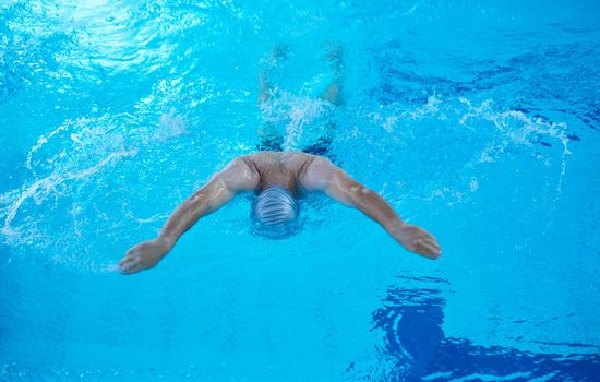 swimmer excercise on indoor swimming pool, sport and health concept