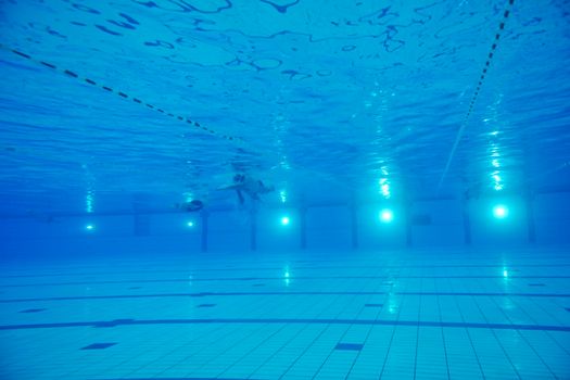 sport swimming pool  underwater with blue color and swimmers