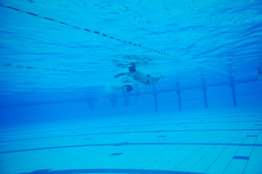 sport swimming pool  underwater with blue color and swimmers