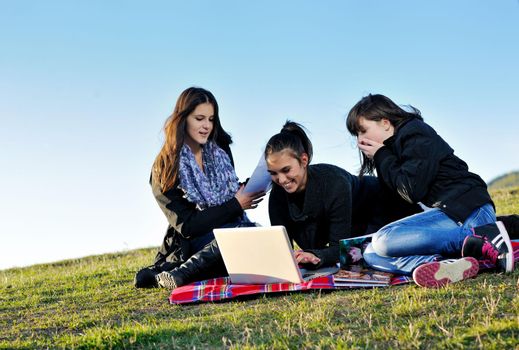 group of teen girl woman outdoor have fun and study homework on laptop computer