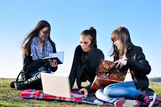 group of teen girl woman outdoor have fun and study homework on laptop computer