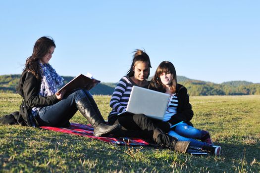 group of teen girl woman outdoor have fun and study homework on laptop computer