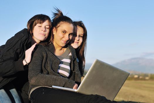 group of teen girl woman outdoor have fun and study homework on laptop computer