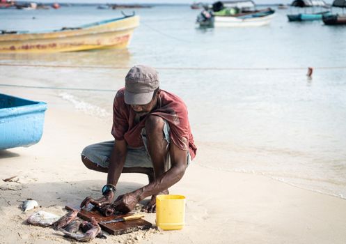 Candid black fisherman on the coast ocean