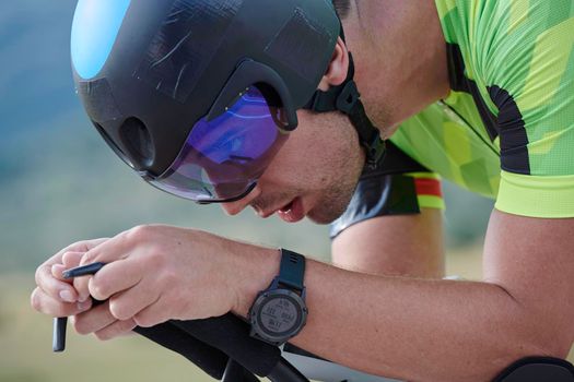 triathlon athlete riding professional racing bike at workout on curvy country road