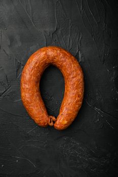 Hot Smoked sausage set, on black dark stone table background, top view flat lay, with copy space for text