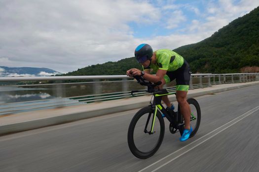 triathlon athlete riding racing bike on morning training urban enviroment