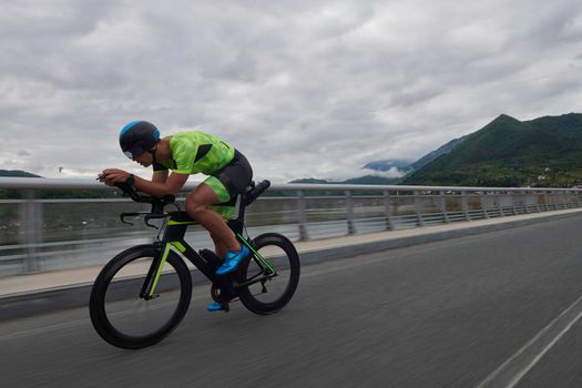 triathlon athlete riding racing bike on morning training urban enviroment