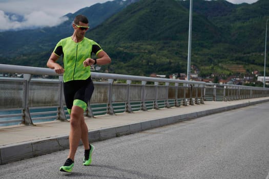 triathlon athlete running on street urban enviroment morning training workout