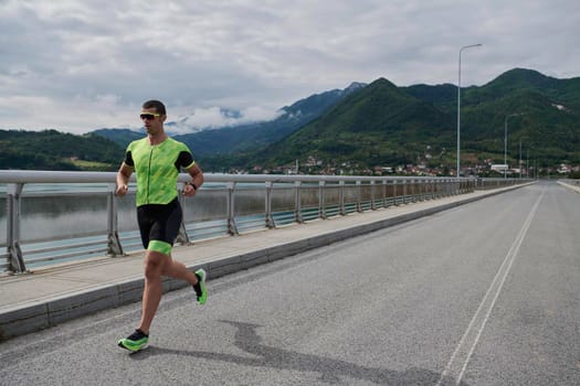 triathlon athlete running on street urban enviroment morning training workout