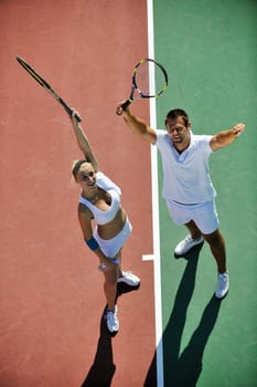 happy young couple play tennis game outdoor man and woman