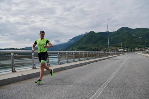 triathlon athlete running on street urban enviroment morning training workout