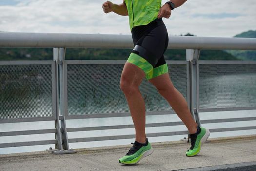 triathlon athlete running on street urban enviroment morning training workout