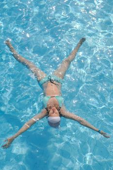 happy young woman relax at swimming pool at vacation travel resort 