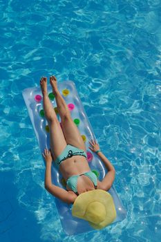 happy young woman relax at swimming pool at vacation travel resort 