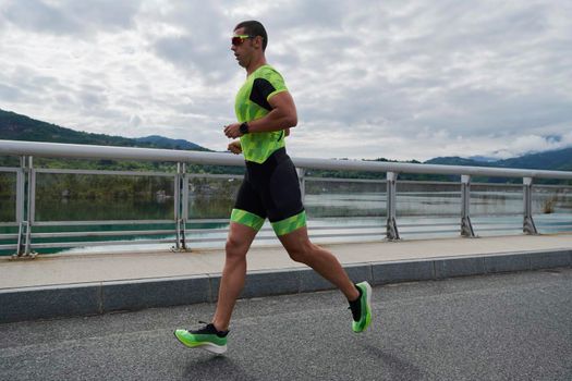 triathlon athlete running on street urban enviroment morning training workout