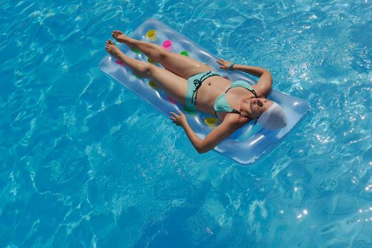 happy young woman relax at swimming pool at vacation travel resort 