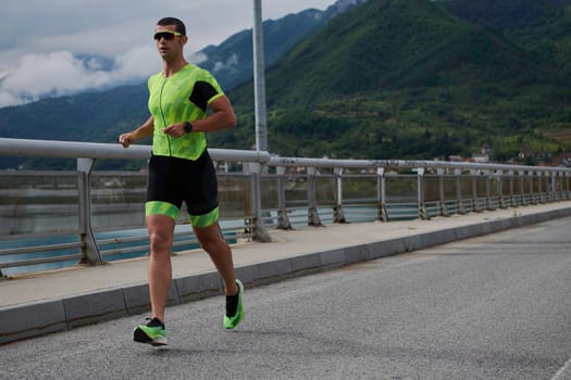 triathlon athlete running on street urban enviroment morning training workout