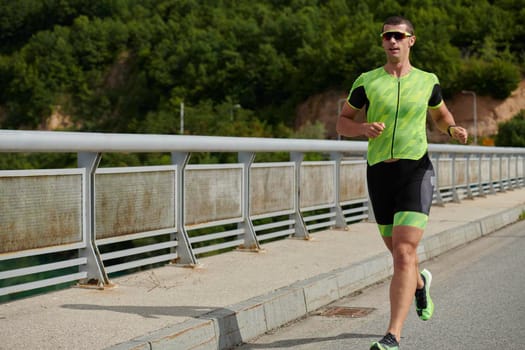 triathlon athlete running on street urban enviroment morning training workout