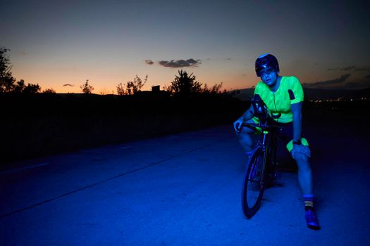 triathlon athlete portrait on break while resting of riding bike on training