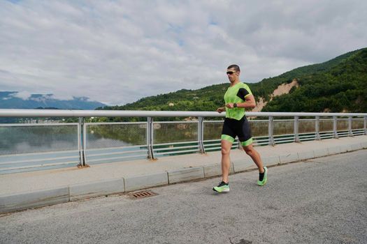 triathlon athlete running on street urban enviroment morning training workout