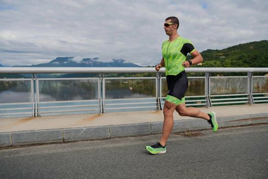 triathlon athlete running on street urban enviroment morning training workout