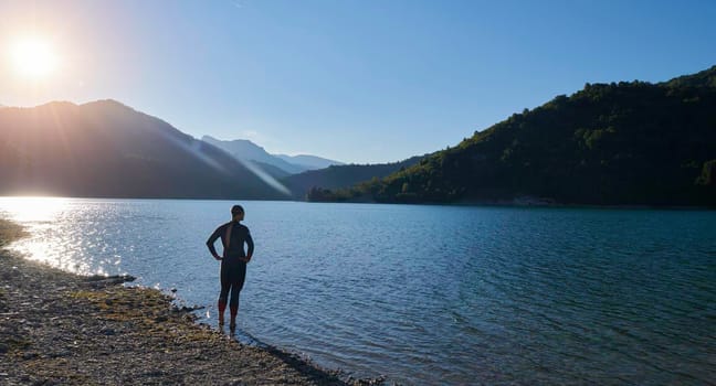 triathlon athlete start swimming training splashing water while running and jumping