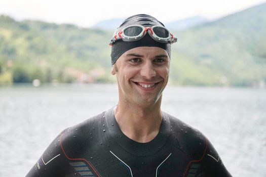 authentic triathlete swimmer portrait wearing wetsuit on morning  training