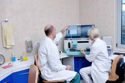 portrait of a veterinarian and assistant in a small animal clinic at work