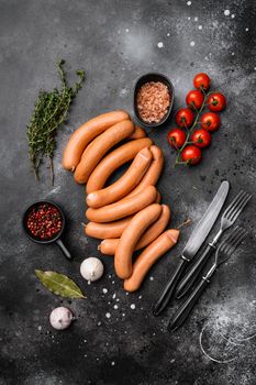 Sausages, on black dark stone table background, top view flat lay