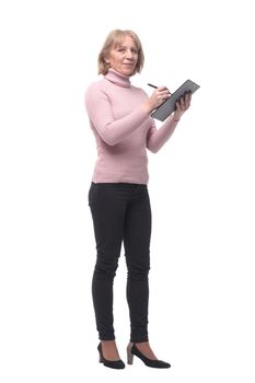 Full length portrait of smiling business woman pointing on blank clipboard isolated over white background